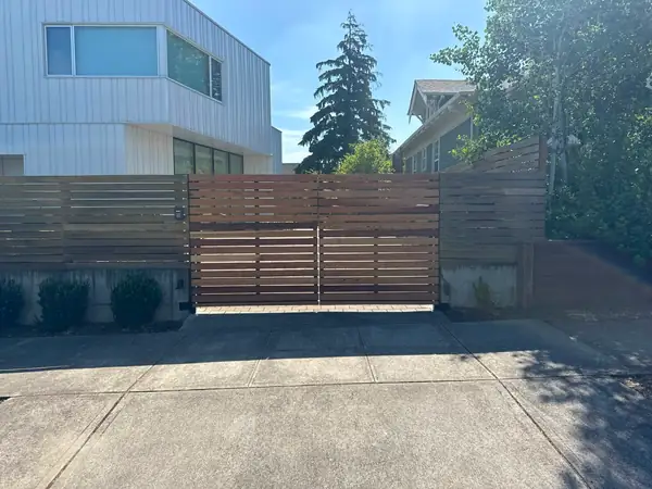 Modern horizontal cedar slat driveway gate with keypad, finished